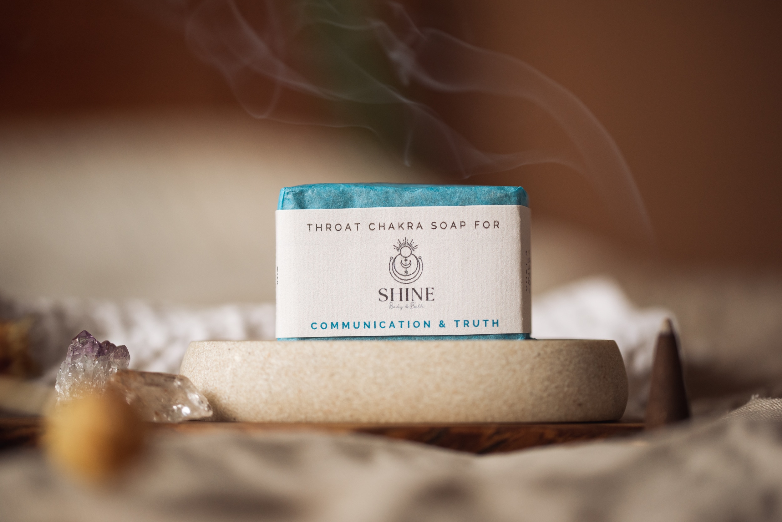 Throat Chakra Soap, wrapped on stone soap dish with smoking blurred incense cone and crystals | Shine Body & Bath