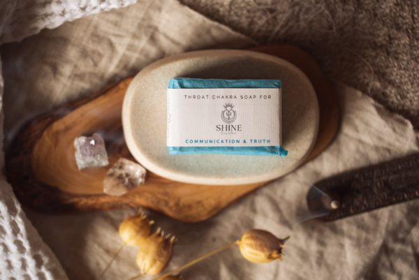 Throat Chakra Soap, wrapped on stone soap dish with smoking blurred incense cone and crystals - overhead | Shine Body & Bath