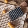 Throat Chakra Soap, unwrapped on cream waffle linen with smoking incense cone, flower buds and crystals | Shine Body & Bath