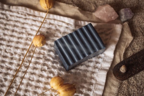 Throat Chakra Soap, unwrapped on cream waffle linen with smoking incense cone, flower buds and crystals | Shine Body & Bath