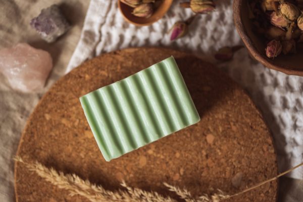 Heart Chakra Soap, unwrapped on cork board and cream waffle fabric with dried ear of grass and bowl of rose buds | Shine Body & Bath