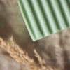 Up close corner of Heart Chakra Soap, unwrapped on cream linen with dried ear of grass | Shine Body & Bath