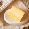 Solar Plexus Chakra Soap, unwrapped on stone soap dish and cream linen with scattered dried lemon slices | Shine Body & Bath