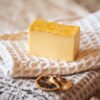 olar Plexus Chakra Soap, unwrapped on cream waffle fabric with two dried lemon slices and crystals | Shine Body & Bath