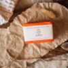 Sacral Chakra Soap, wrapped on crumpled brown paper with string, dried grass and crystals | Shine Body & Bath