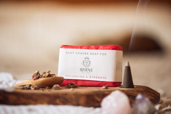 Root Chakra Soap, wrapped on wooden board with smoking incense cone, scattered dried petals and crystals | Shine Body & Bath