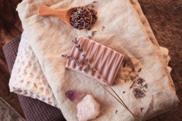 Third Eye Chakra Soap, unwrapped on cream and purple linen tea towels with lavender and crystals | Shine Body & Bath