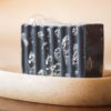 Throat Chakra Soap, with bubbles sitting on a stone soap dish | Shine Body & Bath