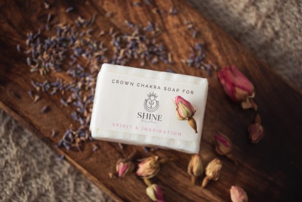 Crown Chakra Soap, wrapped on wooden board with rose buds and scattered lavender petals | Shine Body & Bath
