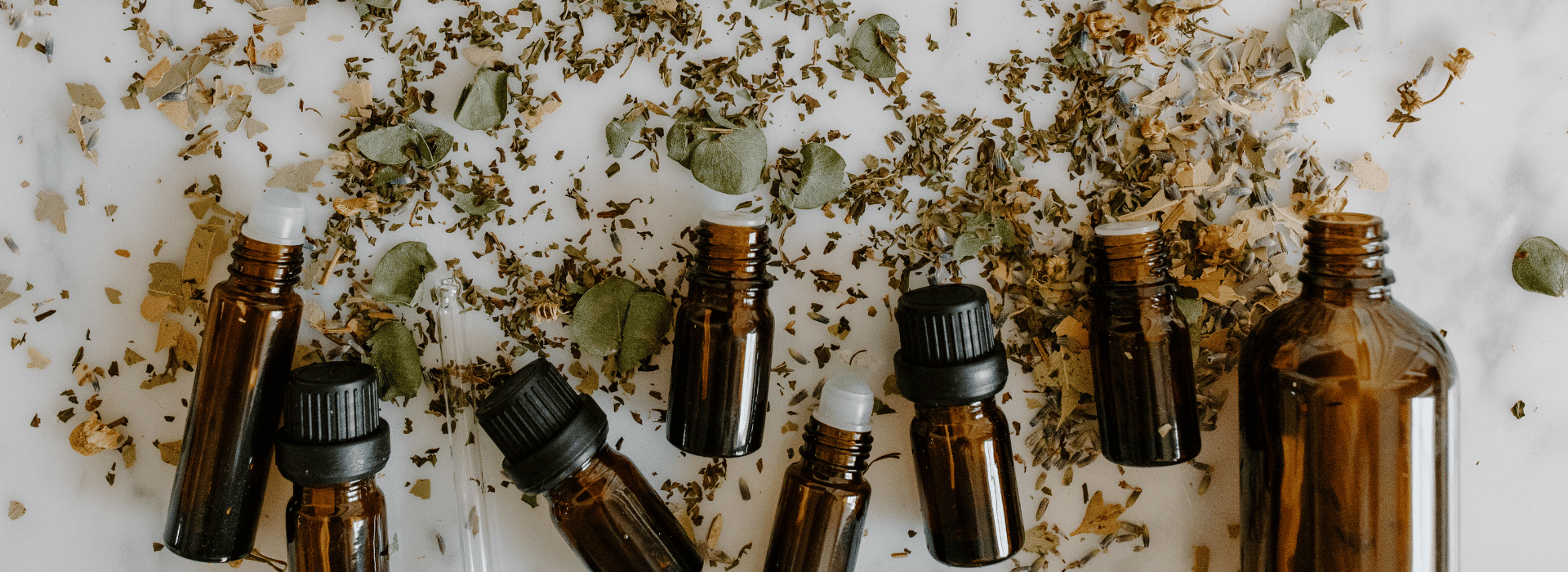 Our Key Ingredients Blog | Essential Oil bottles and petals | Shine Body & Bath