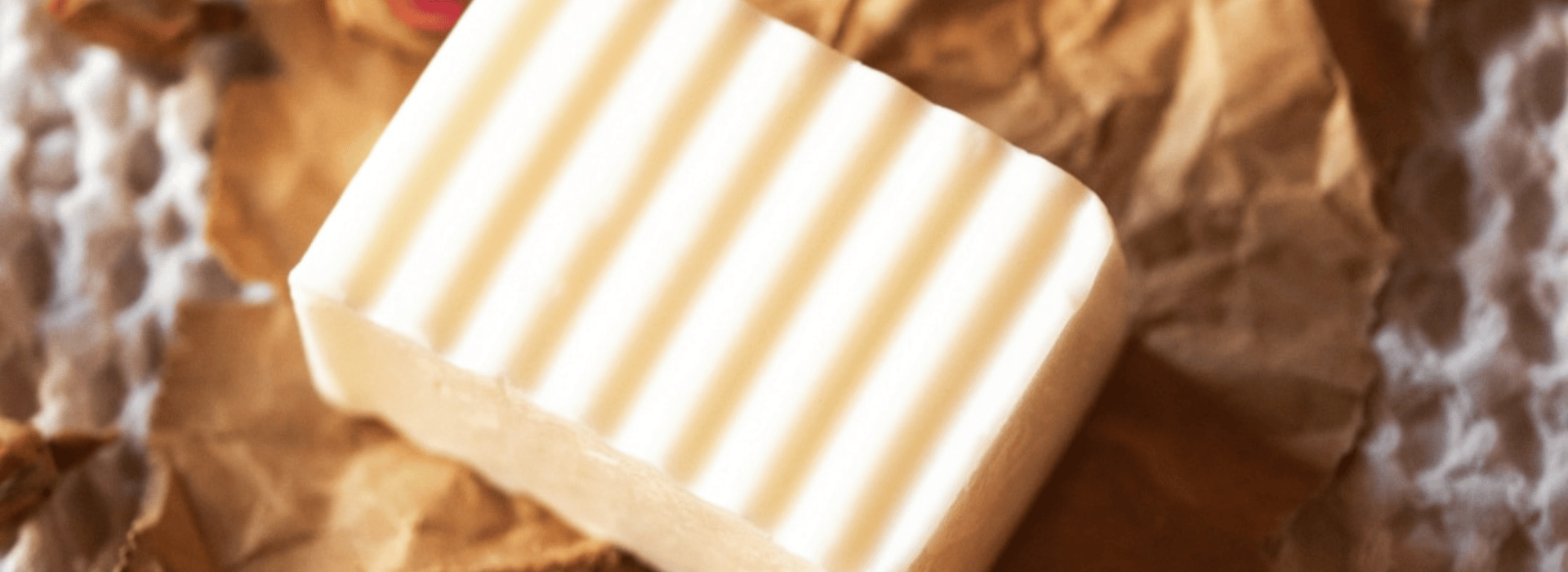 Close up of unwrapped white Crown Chakra Soap on natural background | Natural skincare – what’s the big deal? | Shine Body & Bath Chakra Soap | Blog