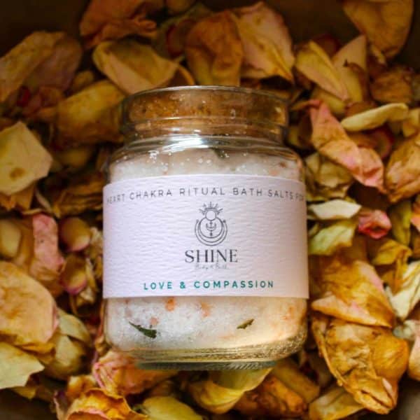 Heart Chakra Ritual Bath Salts for Love & Compassion | Glass jar of bath salts on bed of rose petals | Shine Body & Bath