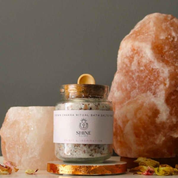 Crown Chakra Ritual Bath Salts for Spirit & Inspiration | Glass jar of bath salts on shelf with large salt lamp and candle holder | Shine Body & Bath