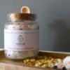 Root Chakra Ritual Bath Salts for Grounding & Strength | Glass jar of bath salts with petals | Shine Body & Bath