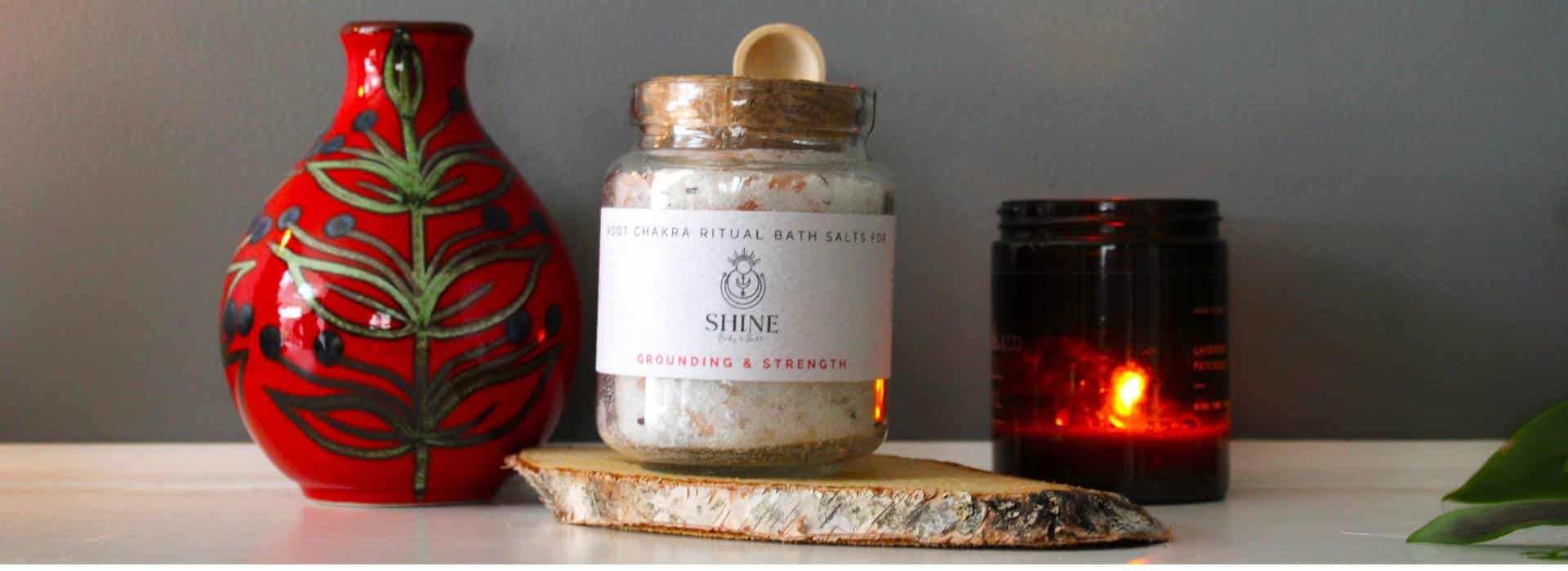 Root Chakra Ritual Bath Salts, vase and candle on shelf | 9 Different Ways to Use Shine Body & Bath Products | Blog