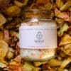 Sacral Chakra Ritual Bath Salts for Sensuality & Joy | Glass jar of bath salts on bed of petals | Shine Body & Bath