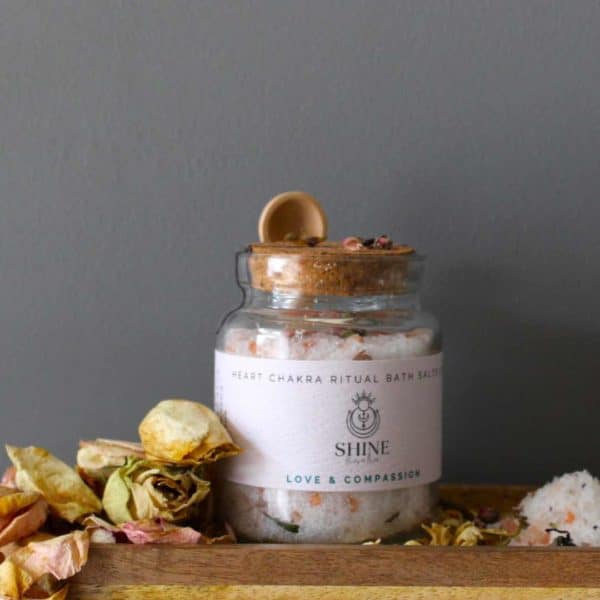Heart Chakra Ritual Bath Salts for Love & Compassion | Glass jar of bath salts on shelf with rose petals | Shine Body & Bath