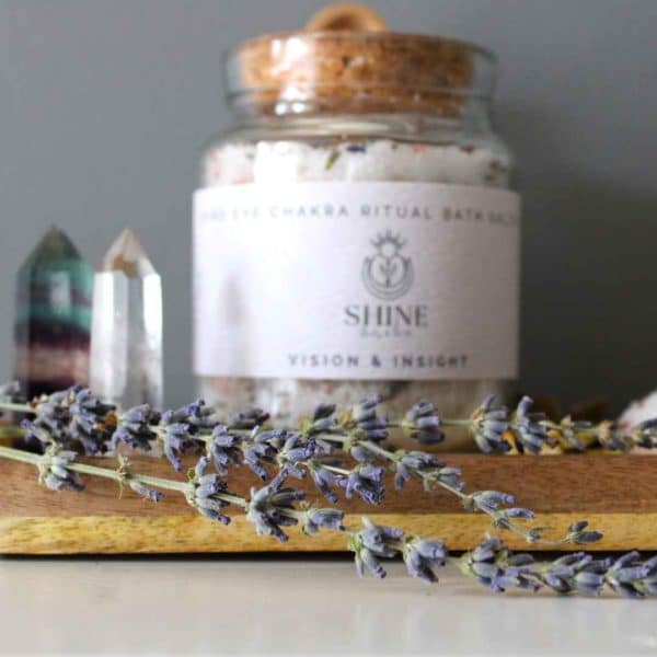 Third Eye Chakra Ritual Bath Salts for Vision & Insight | Glass jar of bath salts on shelf with lavender stems in foreground | Shine Body & Bath
