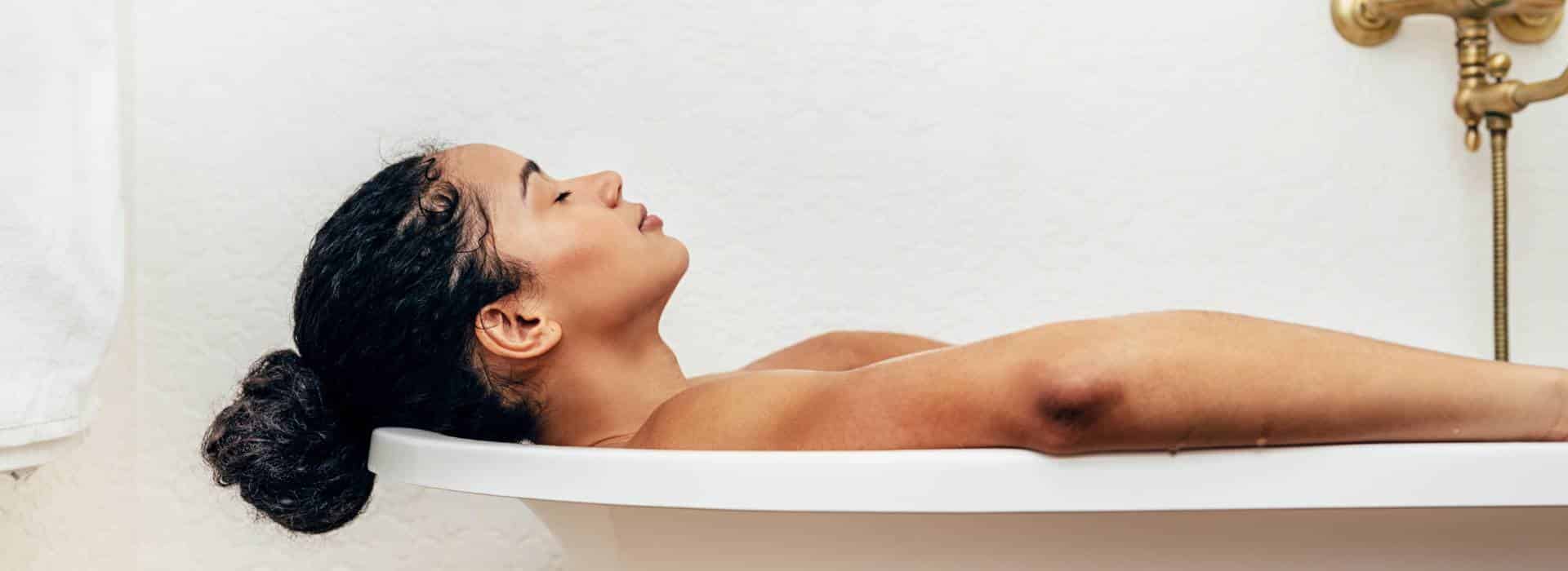 Woman relaxing in bath | 9 Different Ways to Use Shine Body & Bath Products | Blog