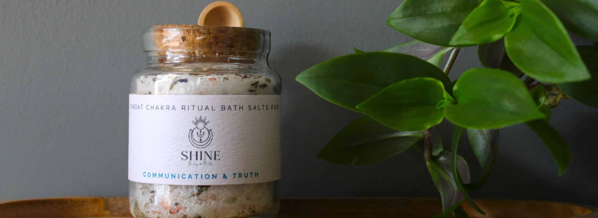 Throat Chakra Bath Salts for Communication & Truth on a shelf with greenery | The Perfect Bath: Create the Ultimate Ritual Bathing Experience | Shine Body & Bath Blog