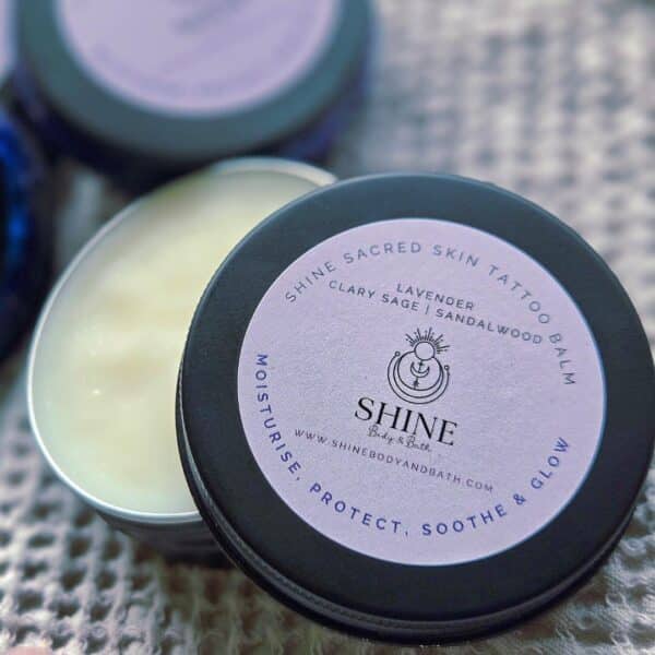 Shine Sacred Skin Tattoo Balm | Flat lay of tins of balm super close up
