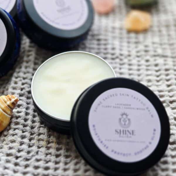 Shine Sacred Skin Tattoo Balm | Flat lay of tins of balm close up