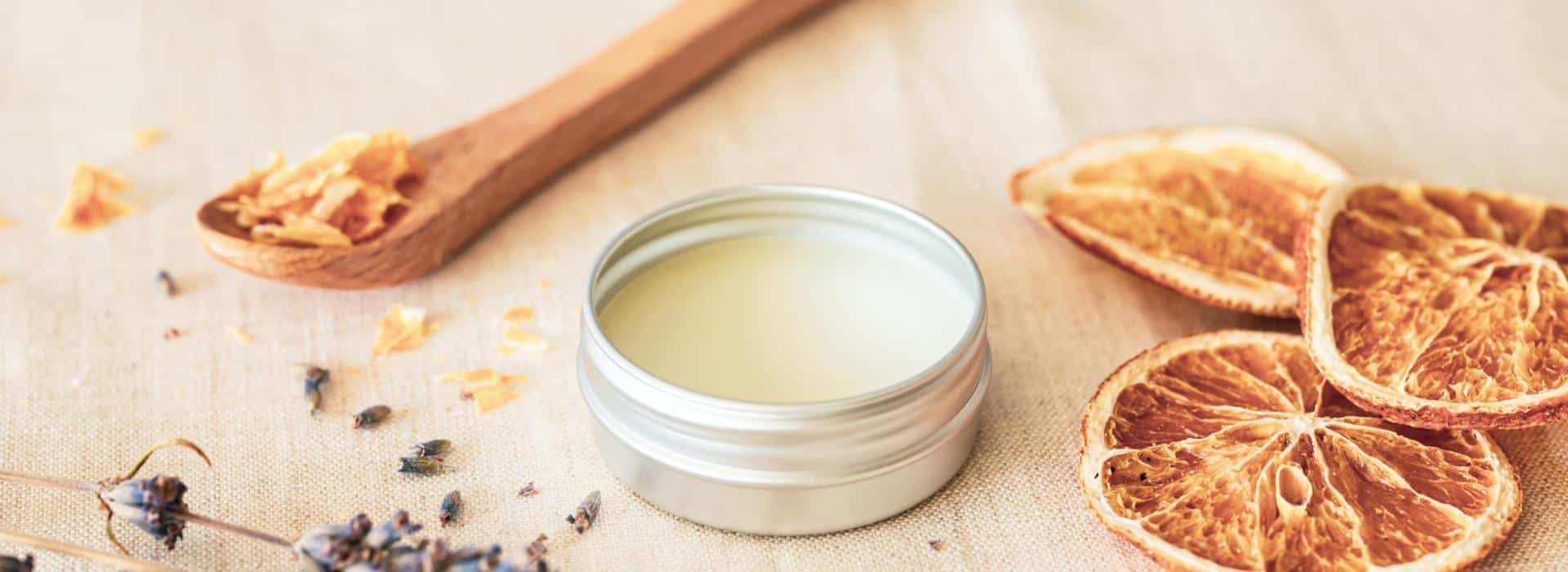 Sacred Skin: Why a Tattoo Balm is Essential for Your Ink (and Your Soul) | Image of balms and botanicals on a board