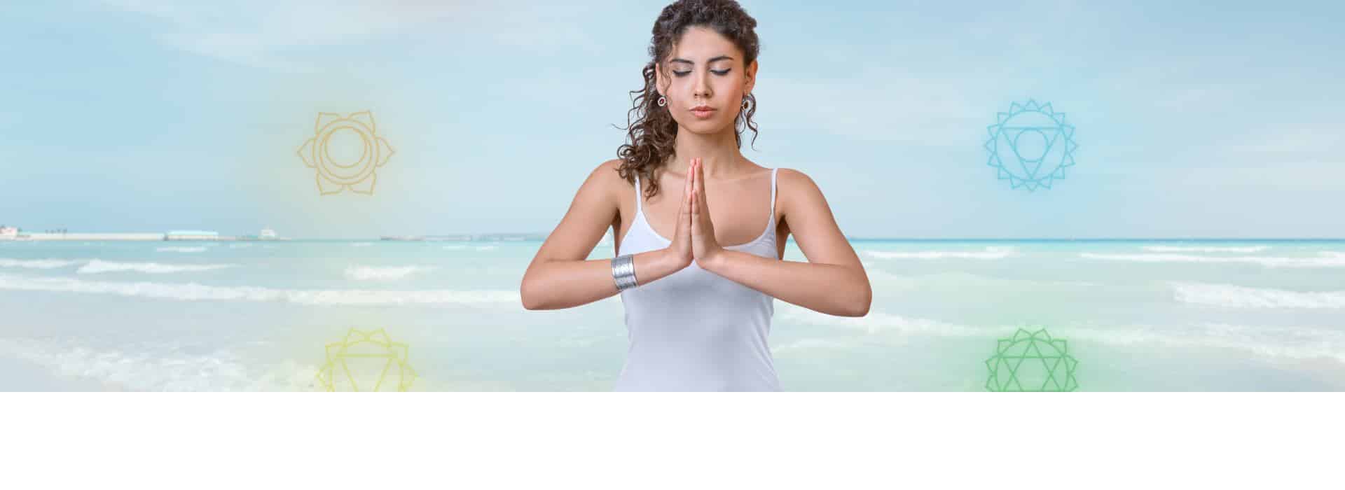 The Chakra System for Beginners - Your Complete Guide | Woman in prayer pose