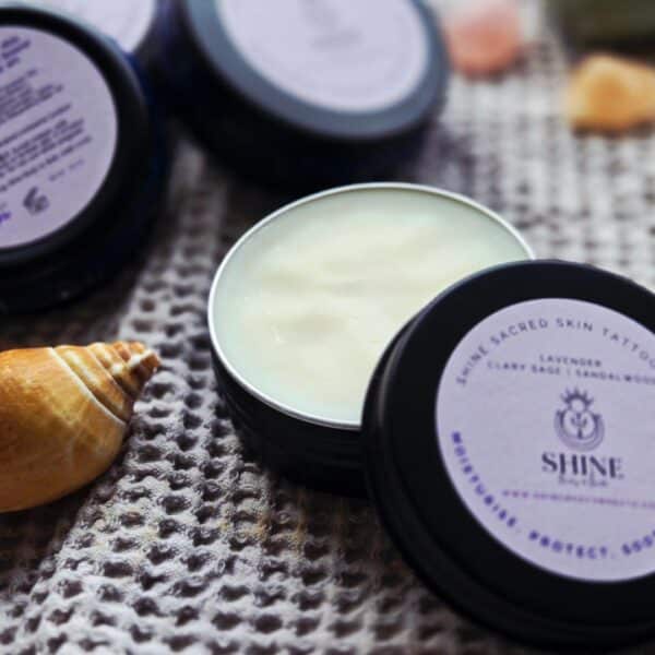 Shine Sacred Skin Tattoo Balm | Flat lay of tins of balm 2