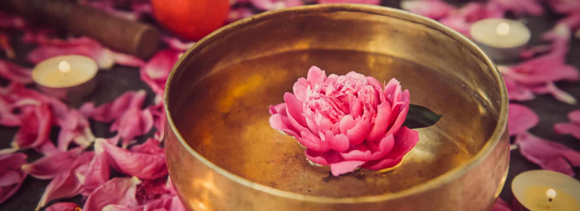 Essential Oils for Chakra Healing: Simple Scents to Balance Your Energy Blog | Flower floating in a copper bowl