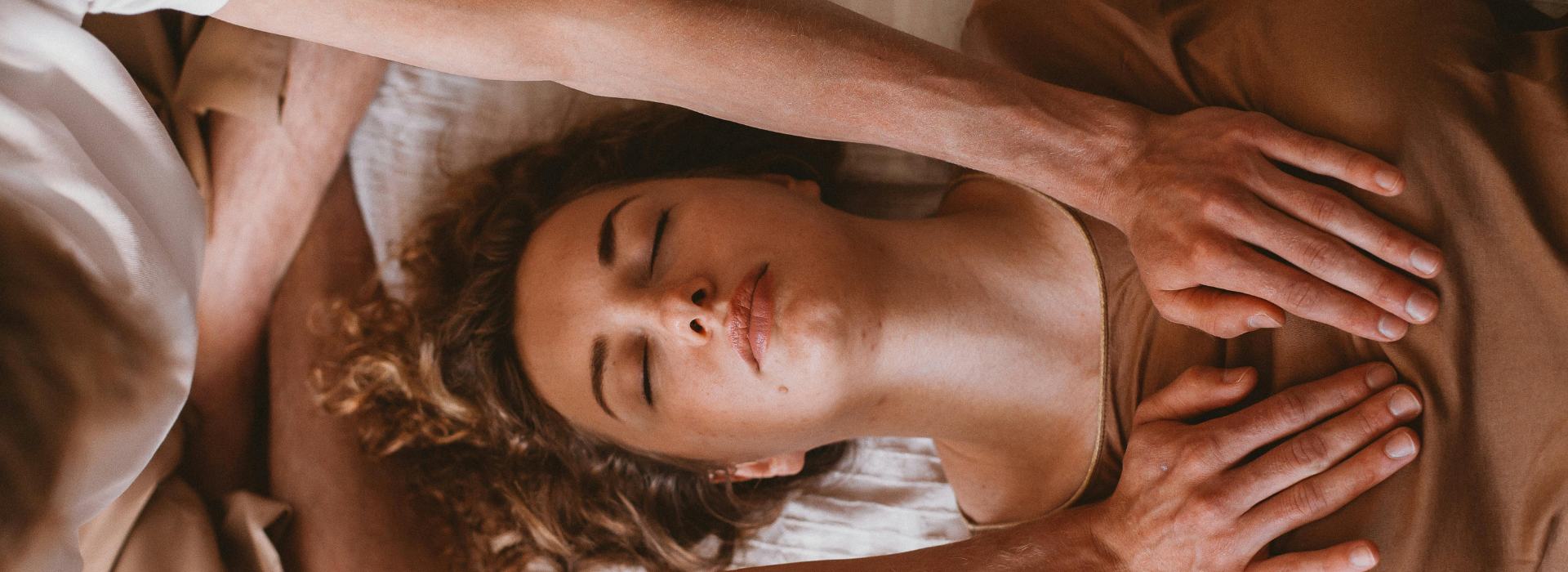 The Chakra System for Beginners - Your Complete Guide | Practitioner hands on woman's chest