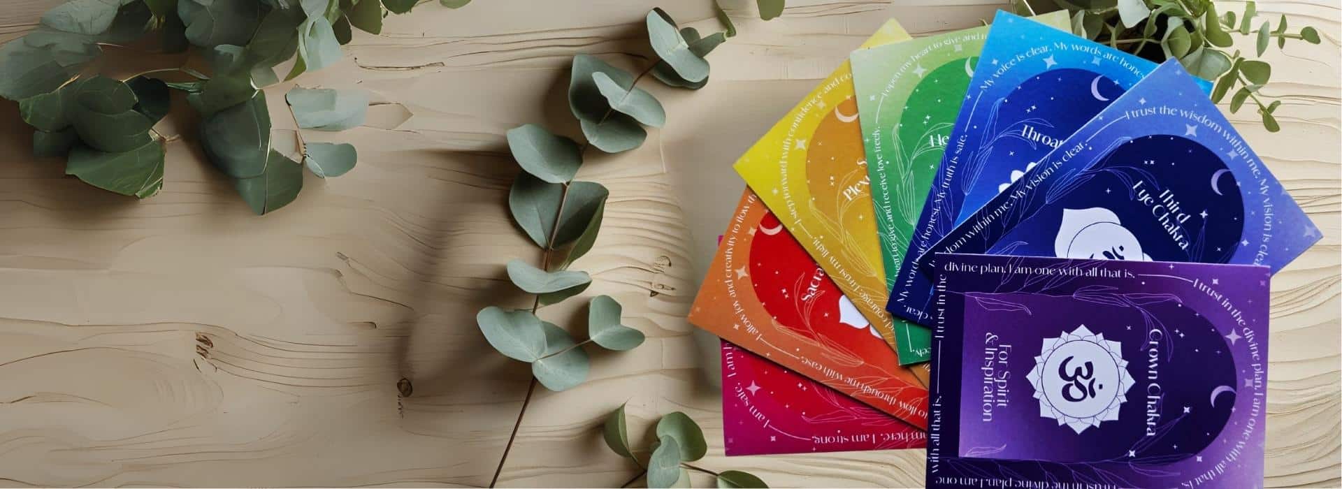 Image of Chakra Affirmation Greetings Cards on wooden board with eucalyptus