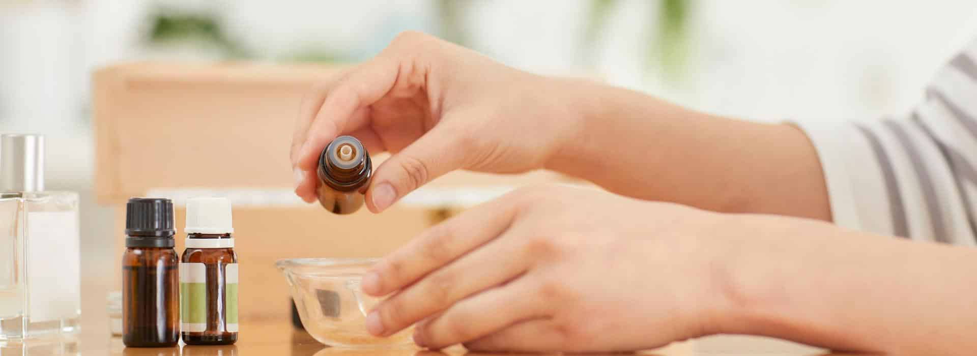 Essential Oils for Chakra Healing: Simple Scents to Balance Your Energy Blog | Woman dropping essential oils into a bowl